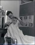 A young Doug Belden receives a haircut in Tampa, Florida, A