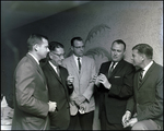 Five men in the Better Home Heat Council speak closely in Tampa, Florida
