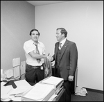 Jerry Bowmer Posing by Shaking Hands with Employee at Courthouse by Skip Gandy