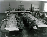 Men, Women, and Children Sit at Tables Waiting to Eat at the Aunt Jemima Pancake Jamboree by Skip Gandy