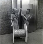 Two Boy Scouts Looking at a Cord Made of Pennies, B by Skip Gandy