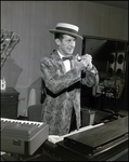 Musician Performing in Front of Pianos by Skip Gandy