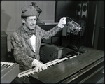 Musician Playing Piano While Holding a Lantern by Skip Gandy