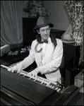 Musician Wearing an Umbrella Around His Neck While Playing the Piano by Skip Gandy