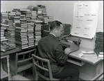 A Man Creating Cataloging Cards for Books, Berkeley Preparatory School, Tampa, Florida by Skip Gandy