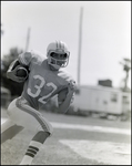 An Offensive Football Player Cradles the Ball During a Play, Berkeley Preparatory School, Tampa, Florida, C by Skip Gandy