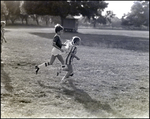 Two Children Run for a Soccer Ball, Berkeley Preparatory School, Tampa, Florida by Skip Gandy