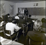 An Instructor Speaks at the Front of a Classroom at Berkeley Preparatory School in Tampa, Florida, A by Skip Gandy