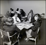 Four Students Laugh and Play a Card Game in Class at Berkeley Preparatory School in Tampa, Florida by Skip Gandy