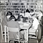 Four Boys Read and Chat Around a Table in the Library at Berkeley Preparatory School in Tampa, Florida by Skip Gandy