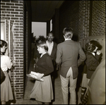 A Man Navigates Between Students in the Breezeway at Berkeley Preparatory School in Tampa, Florida by Skip Gandy