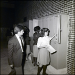 A Boy Waits Beside a Girl Sorting Through Her Locker at Berkeley Preparatory School in Tampa, Florida