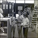 Three Children Read a Pamphlet About the Spring Art Festival at Berkeley Preparatory School in Tampa, Florida by Skip Gandy