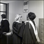 A School Official Helps a Peer Adjust Her Academic Regalia for Commencement at Berkeley Preparatory School in Tampa, Florida by Skip Gandy