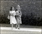 Two Students Chat Casually While Walking Between Classes at Berkeley Preparatory School in Tampa, Florida by Skip Gandy