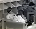 A Boy Ponders Thoughtfully in the Library at Berkeley Preparatory School in Tampa, Florida