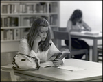 A Girl Reads Lord of the Flies in the Library at Berkeley Preparatory School in Tampa, Florida by Skip Gandy