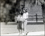 Two Girls Laugh While Walking to Class Outside at Berkeley Preparatory School in Tampa, Florida by Skip Gandy