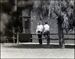 Two Boys Chat Against a Wooden Railing Outside Berkeley Preparatory School in Tampa, Florida by Skip Gandy