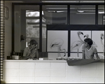 Two School Administrators Work at a Reception Desk in Berkeley Preparatory School in Tampa, Florida by Skip Gandy