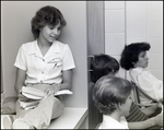 A Girl Reads While Perched on Top of a Cabinet at Berkeley Preparatory School in Tampa, Florida by Skip Gandy