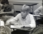 A Boy Looks up While Completing an Assignment at Berkeley Preparatory School in Tampa, Florida