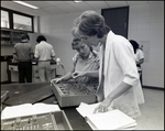 A Teacher Helps a Student Operate a Circuit Board at Berkeley Preparatory School in Tampa, Florida by Skip Gandy