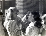 Two Girls Speak Animatedly in a Crowd at Berkeley Preparatory School in Tampa, Florida by Skip Gandy