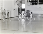 Students Play a Game of Hockey in the Gymnasium at Berkeley Preparatory School in Tampa, Florida, A by Skip Gandy