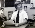 A Boy Smiles at Something Out of Frame While Working in Class at Berkeley Preparatory School in Tampa, Florida