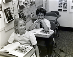 Two Children Laugh While Reading in Class at Berkeley Preparatory School in Tampa, Florida by Skip Gandy