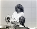 A Girl Holds a Flower Made of Tissue Paper at Berkeley Preparatory School in Tampa, Florida by Skip Gandy