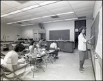 A Science Teacher Writes on the Chalkboard at Berkeley Preparatory School in Tampa, Florida by Skip Gandy