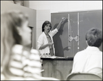 A Science Teacher Demonstrates Something on the Chalkboard at Berkeley Preparatory School in Tampa, Florida by Skip Gandy