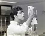 A Student Checks His Findings During Science Class at Berkeley Preparatory School in Tampa, Florida by Skip Gandy