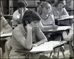 A Student Looks at His Textbook in Disinterest at Berkeley Preparatory School in Tampa, Florida by Skip Gandy