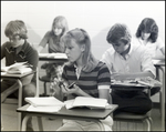 A Student Glances at Her Peer While Using a Calculator at Berkeley Preparatory School in Tampa, Florida by Skip Gandy