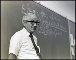 A Math Teacher Explains Equations on the Chalkboard at Berkeley Preparatory School in Tampa, Florida, B by Skip Gandy