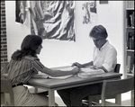 A Girl Helps Her Peer Study in the Library at Berkeley Preparatory School in Tampa, Florida by Skip Gandy