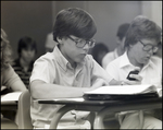 A Boy Consults His Calculator in Class at Berkeley Preparatory School in Tampa, Florida