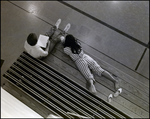 A Girl Lounges Barefoot Across the Bleachers While Her Friend Studies at Berkeley Preparatory School in Tampa, Florida, A by Skip Gandy