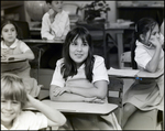 A Girl Smiles Shyly in Class at Berkeley Preparatory School in Tampa, Florida by Skip Gandy