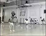 Students Play a Game of Hockey in the Gymnasium at Berkeley Preparatory School in Tampa, Florida, D by Skip Gandy