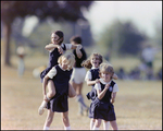 Two Girls Climb Atop Their Friends for Piggyback Rides at Berkeley Preparatory School in Tampa, Florida by Skip Gandy