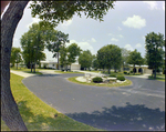 Three Houses Sit on a Cul-de-sac With a Fountain in the Center in Beverly Hills, Florida, A by Skip Gandy