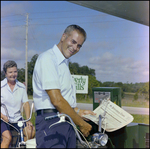 A Couple on Bicycles Grab Copies of the St. Petersburg Times in Beverly Hills, Florida, A