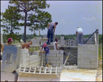 A Team of Construction Workers Lay a Brick Foundation in Beverly Hills, Florida, A by Skip Gandy