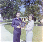 Man and Woman Accept Award for Rolling Oaks Corporation in Beverly Hills, Florida, J by Skip Gandy