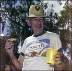 Man in Straw Hat Eats Watermelon in Beverly Hills, Florida, B by Skip Gandy