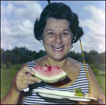 Woman Smiles Brightly Over Plate of Watermelon in Beverly Hills, Florida by Skip Gandy